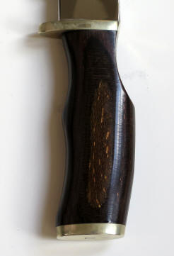 The guard is NOT forged into the blade nor is there a lanyard pommel